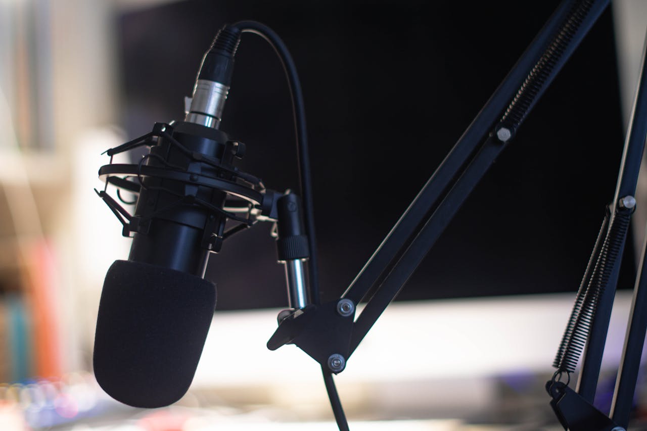 hero-img Close-up of a condenser microphone in a studio setting, ideal for podcasts and audio recording.